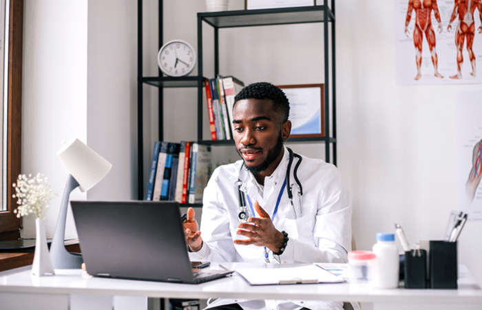 doctor with patient talking on computer in office