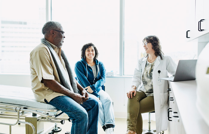 doctor with patient and family member in office
